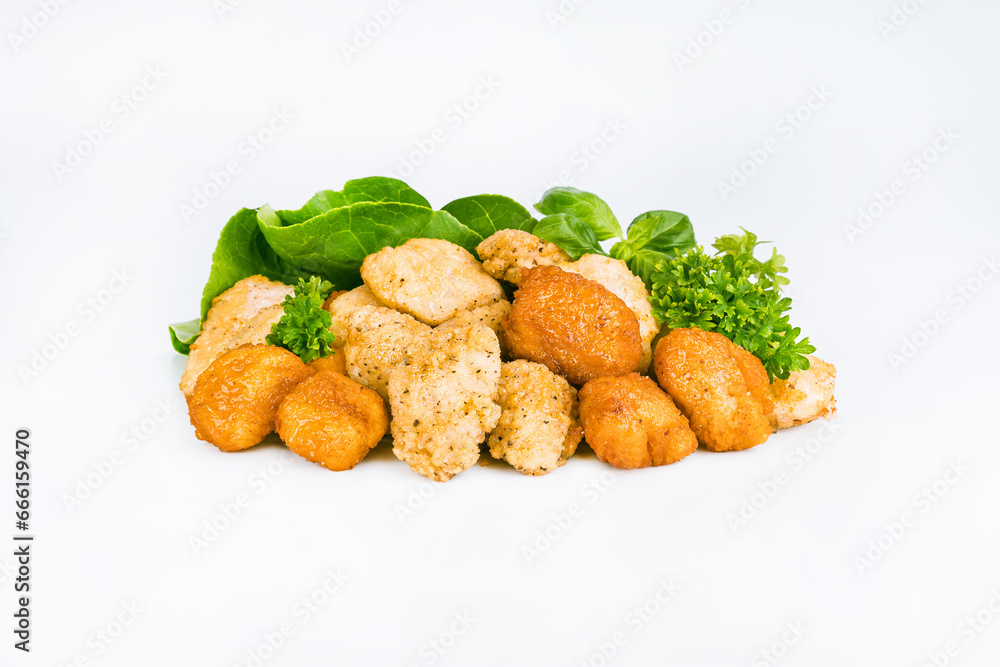 Breaded chicken nuggets.Breaded Chicken Inner Fillet with green lettuce leaves on a White Background.Chicken Breaded Raw Meat,Fillet.Fast homemade food at home. Chicken breaded schnitzels.Fast cooking Breaded chicken nuggets.Breaded Chicken Inner Fillet with green lettuce leaves on a White Background.Chicken Breaded Raw Meat,Fillet.Fast homemade food at home. Chicken breaded schnitzels.Fast cooking