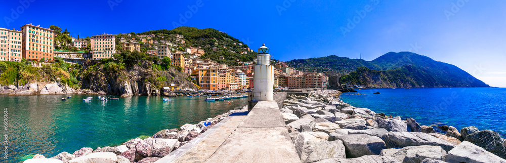 Italy. Camogli - beautiful traditional  village in Liguria, panorama with traditional fishing boats and lighthouse . popular tourist destination