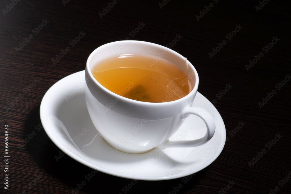 Green tea cup with saucer at table Green tea cup with saucer at table