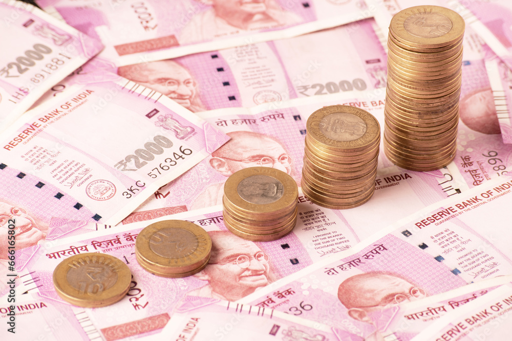 indian coin stack with 2000 rupees bank note indian coin stack with 2000 rupees bank note