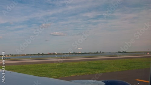 Scenic view from airplane window of New York airport runway, with plane landing on tarmac. New York. USA. photo