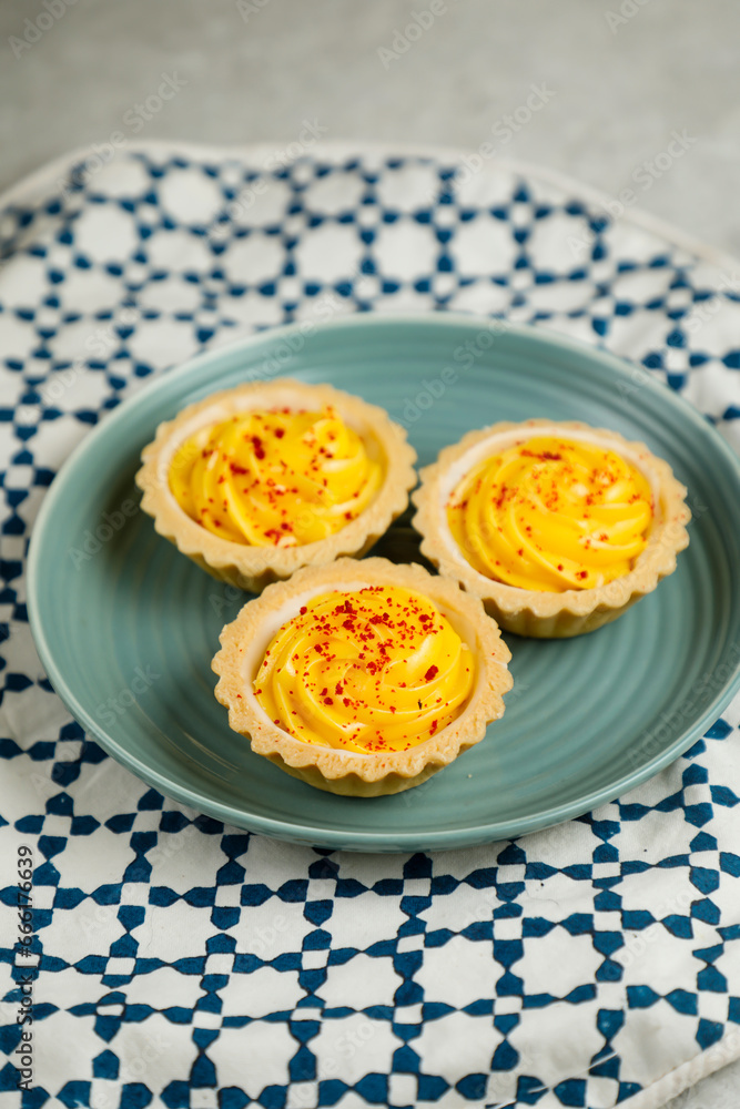 Lemon Tart muffin cup cake served in plate isolated on napkin side view of cafe baked food on background Lemon Tart muffin cup cake served in plate isolated on napkin side view of cafe baked food on background