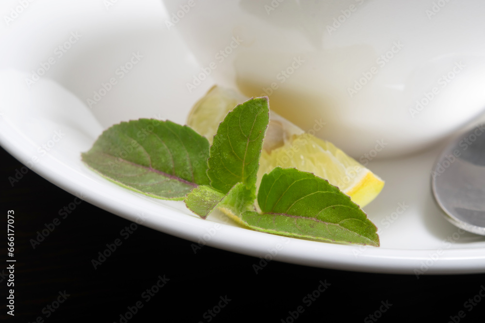 Closeup of tulsi leaf with lemon on plate Closeup of tulsi leaf with lemon on plate