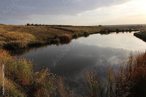 A small pond in a field © parpalac