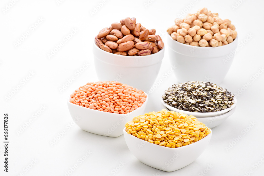 Raw lentils and gram in bowl on white background Raw lentils and gram in bowl on white background