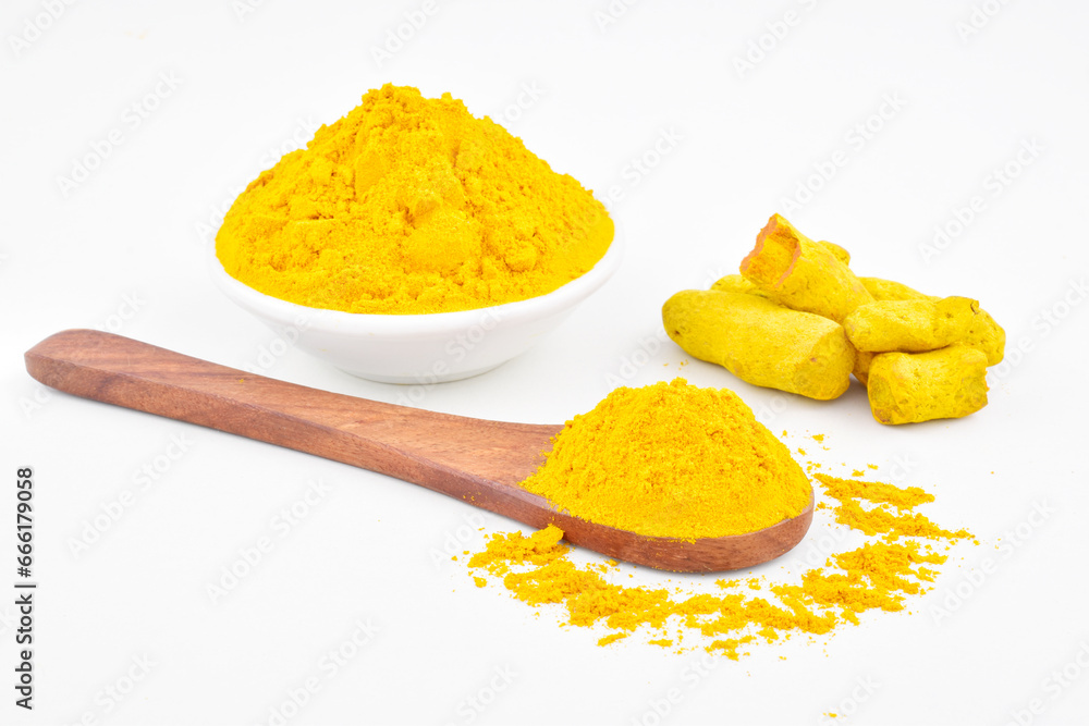Turmeric powder in spoon and bowl on white background Turmeric powder in spoon and bowl on white background