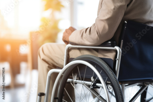 Disabled businessman in wheelchair in office workplace. Concept of inclusive employment and equality in business