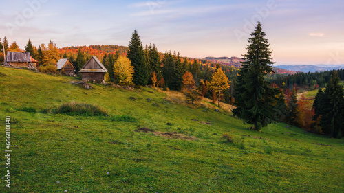 beautiful mountainous countryside landscape of romania in autumn. rolling hills, forested slopes and open vista in evening light. rural tourism concept