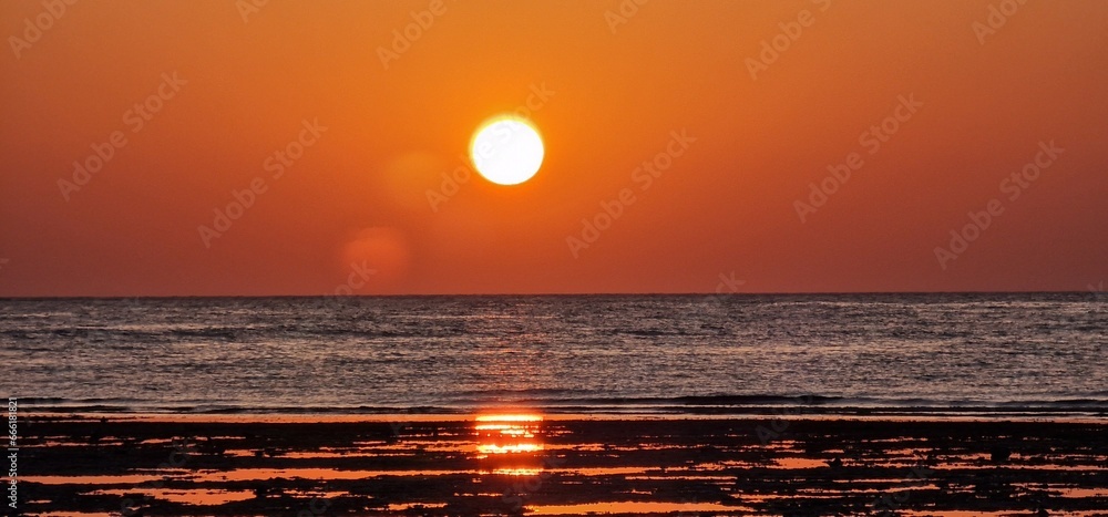sunrise in early morning hours in egypt close to Marsa alam sun reflexion in the red sea