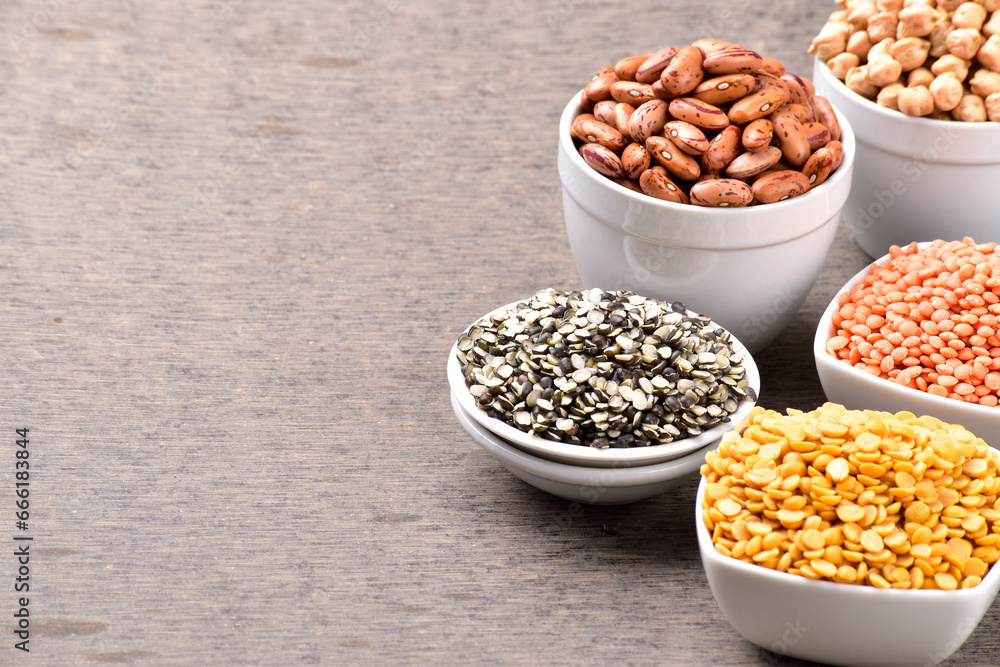 Raw legumes and pulses in bowl, variety of uncooked beans Raw legumes and pulses in bowl, variety of uncooked beans