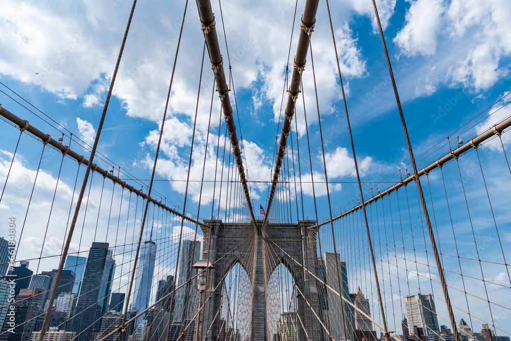 Fototapeta premium architecture of historic bridge in brooklyn. american architecture landmark. way to manhattan. brooklyn bridge in new york. scenery of brooklyn bridge over skyscrapers in metropolis. amazing view