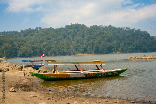 Wooden Boat Rests Peacefully on the Ground at Patenggang Lake photo