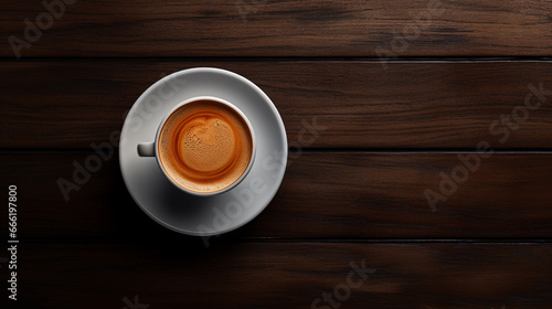 Cup of coffee on the table, top view.