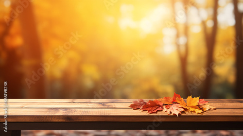 A wooden table is showcased against a blurred  red-yellow leafy backdrop.