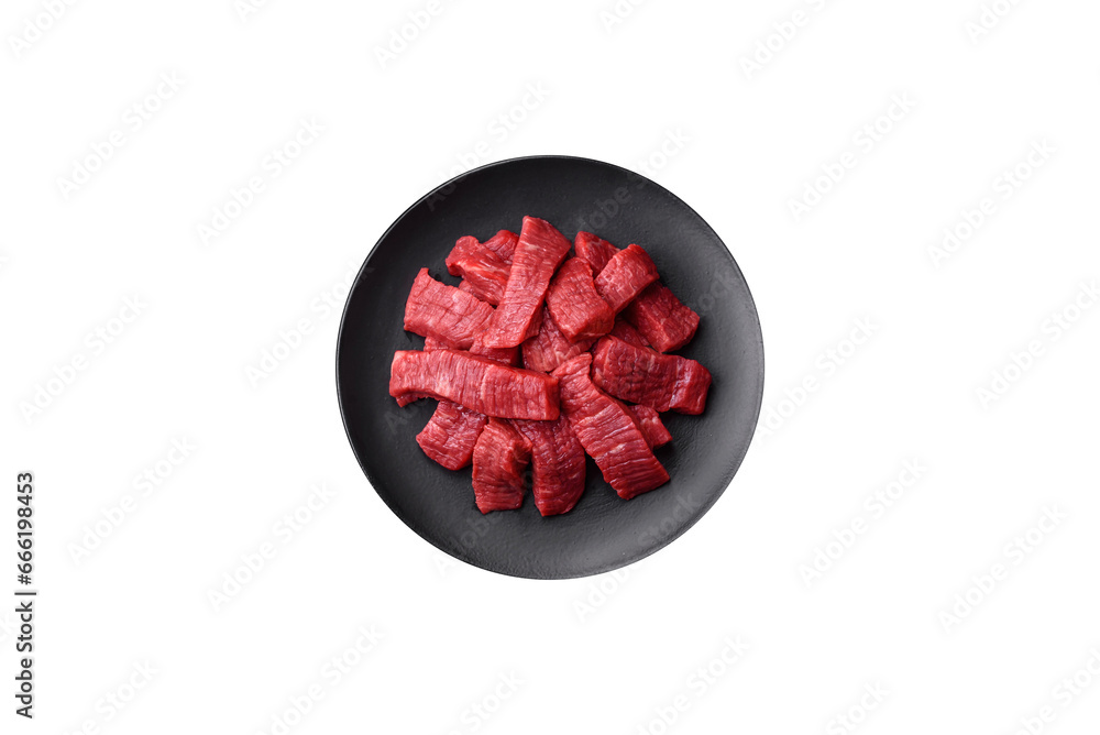 Fresh juicy raw beef slices with salt and spices Fresh juicy raw beef slices with salt and spices