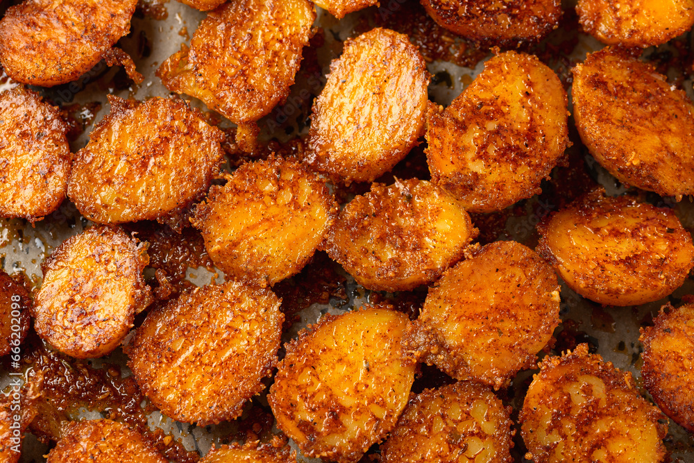 Parmesan crusted baby new potatoes on a baking tray Parmesan crusted baby new potatoes on a baking tray