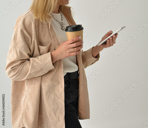 Chic authentic young businesswoman, having a friendly conversation over her smartphone during downtime from work.