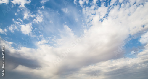 Minimalistic evening sky with clouds and sun glare, looking up at the sky in the evening