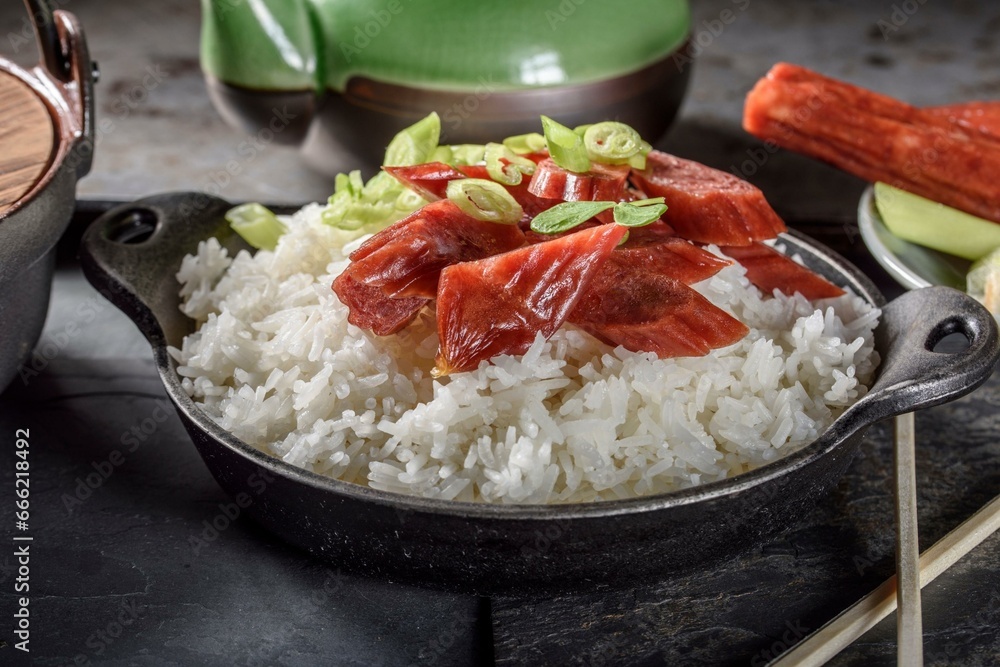 4K Image: Smoked Chinese Sausage Atop Steamed Rice in Elegant Black Ceramic Bowl 4K Image: Smoked Chinese Sausage Atop Steamed Rice in Elegant Black Ceramic Bowl