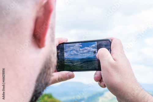 Traveler takes photo on smartphone.