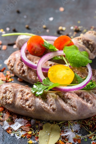 4K Image: Close-Up of Flavorful Italian Sausages with Spices and Fresh Vegetables