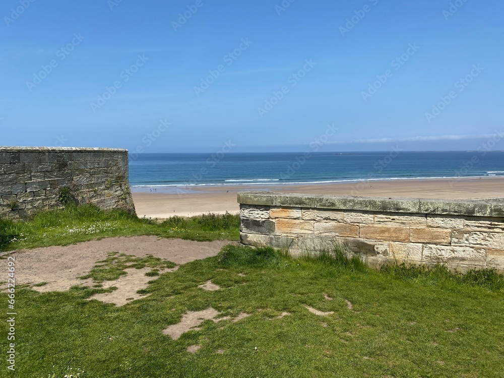 Fototapeta premium Stone Wall and Sandy Beach 2023-05