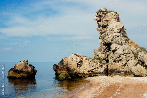 Rocky seashore with a bizarre rock and stones. Seascape