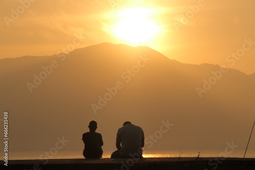 SAD COUPLE DURING NICE SUNSET AT ILHABELA, BRASIL