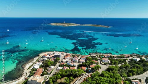 Minorca's vibrant coastline featuring a distant lighthouse.