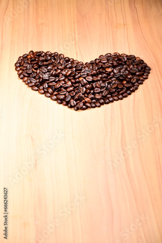 Heart shape coffee bean on wooden background