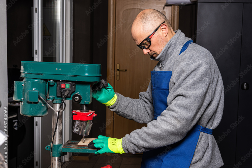 Working on vertical drilling machines in the industrial plant for producing new items Working on vertical drilling machines in the industrial plant for producing new items