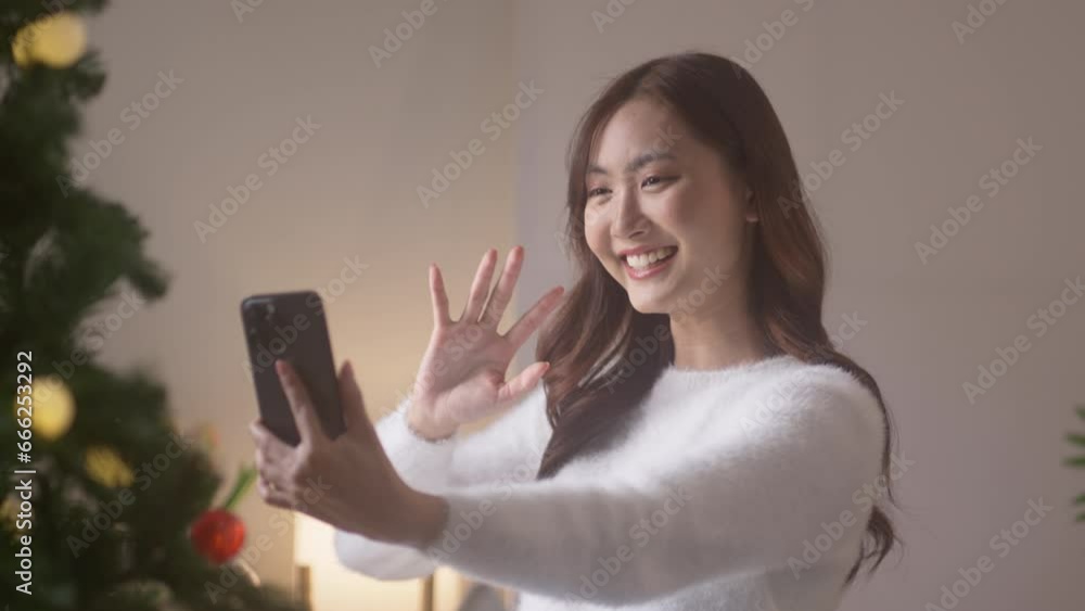 Happy Holidays. Cheerful asian girl speak talk on video call conference in christmas eve. Happy Holidays. Cheerful asian girl speak talk on video call conference in christmas eve.