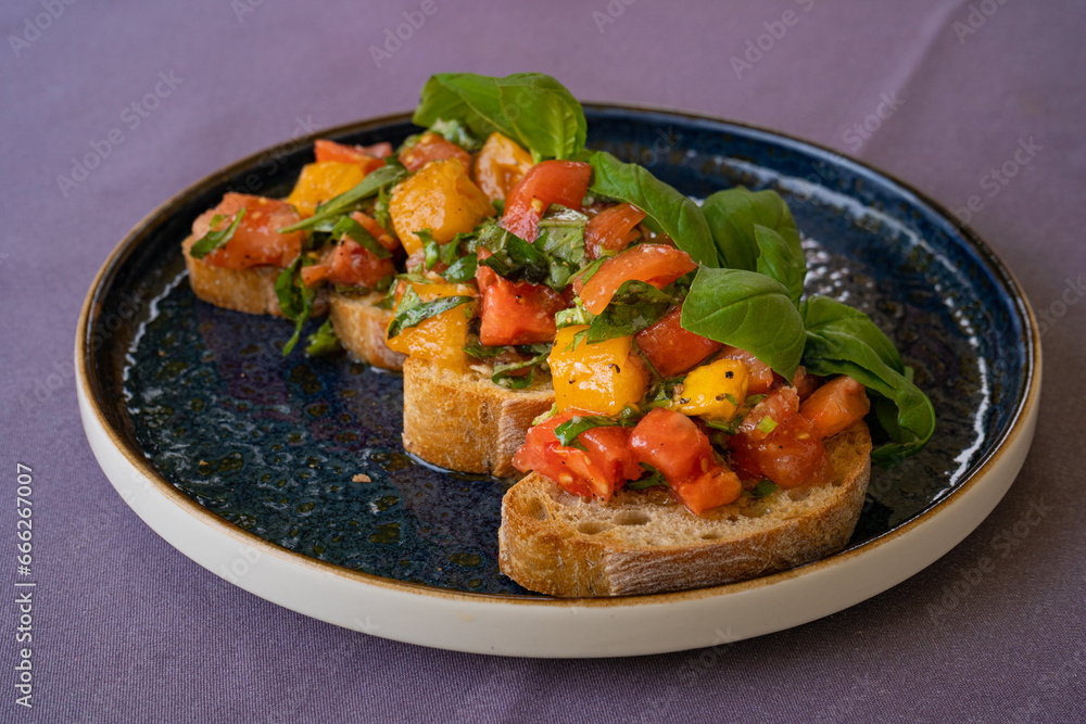 Color Bruschetta, Italian Baguette with Red and Yellow Tomatoes, Basil, Healthy Mediterranean Toast Color Bruschetta, Italian Baguette with Red and Yellow Tomatoes, Basil, Healthy Mediterranean Toast