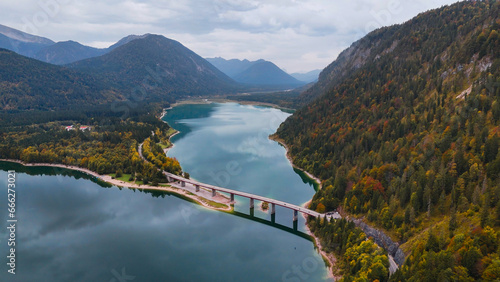 Aerial drone view of Faller-Klamm-Brucke bridge over Silvenstein lake, Karwendel mountain range Alps, Upper Bavaria, Germany in auttumn. photo