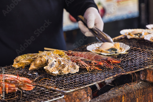 chef at a street kitchen preparing seafood at Tsukiji-market in Tokyo, Japan
