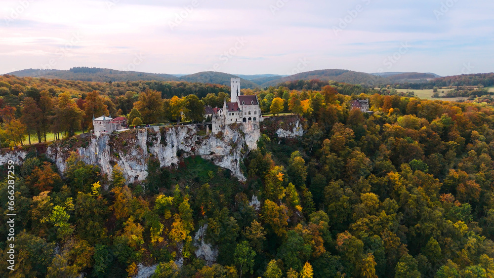 Aerial drone view medieval Lichtenstein castle on mountain, autumn Baden-Wurttemberg, Germany.