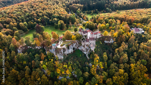 Aerial drone view medieval Lichtenstein castle on mountain, autumn Baden-Wurttemberg, Germany.