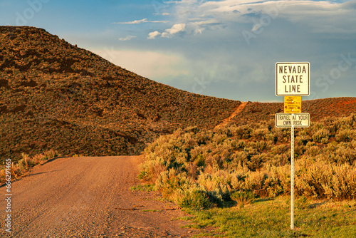 Sign on a remote dirt road in the Smoke Creek Desert of Lassen County California, alerting travelers that they are entering Nevada.