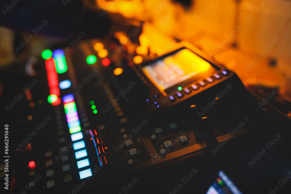 View of lighting technician operator working on mixing console workplace during live conference event, concert show broadcast, light mixer controller panel, workplace sound professional equipment