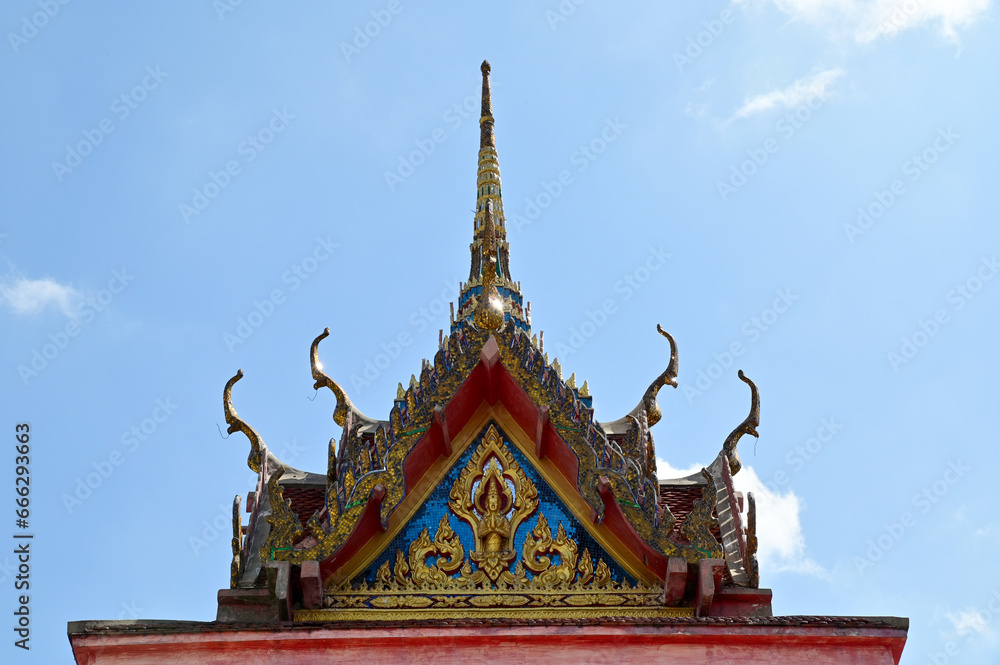 BANGKOK, THAILAND - October 22, 2023 : Part of the Roof of a temple in Thailand. Traditional Thai style pattern on the roof of a temple with Blue Sky Background.