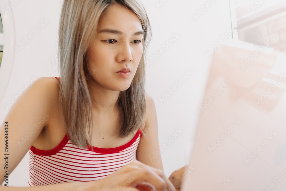 Freelance asian girl working digital online on laptop in the cafe. Freelance asian girl working digital online on laptop in the cafe.