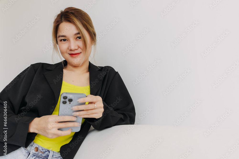 Happy and smile face asian woman using smartphone in white room. Happy and smile face asian woman using smartphone in white room.