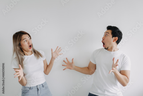 Surprised and shocked face of exciting asian couple lover looking at empty space