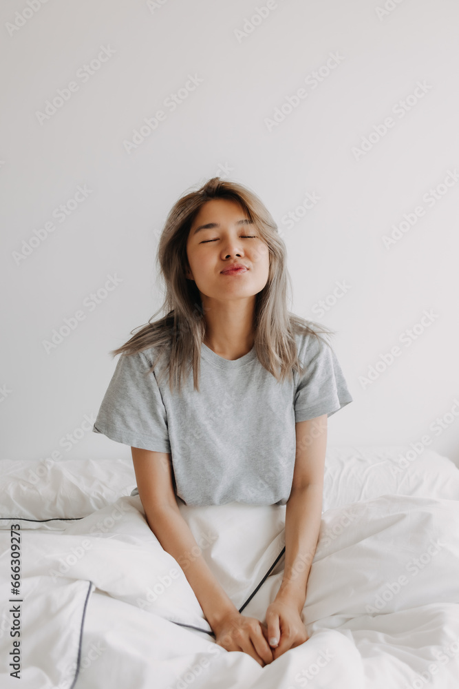 Sleepy and dreaming asian woman just wake up on the bed. Sleepy and dreaming asian woman just wake up on the bed.