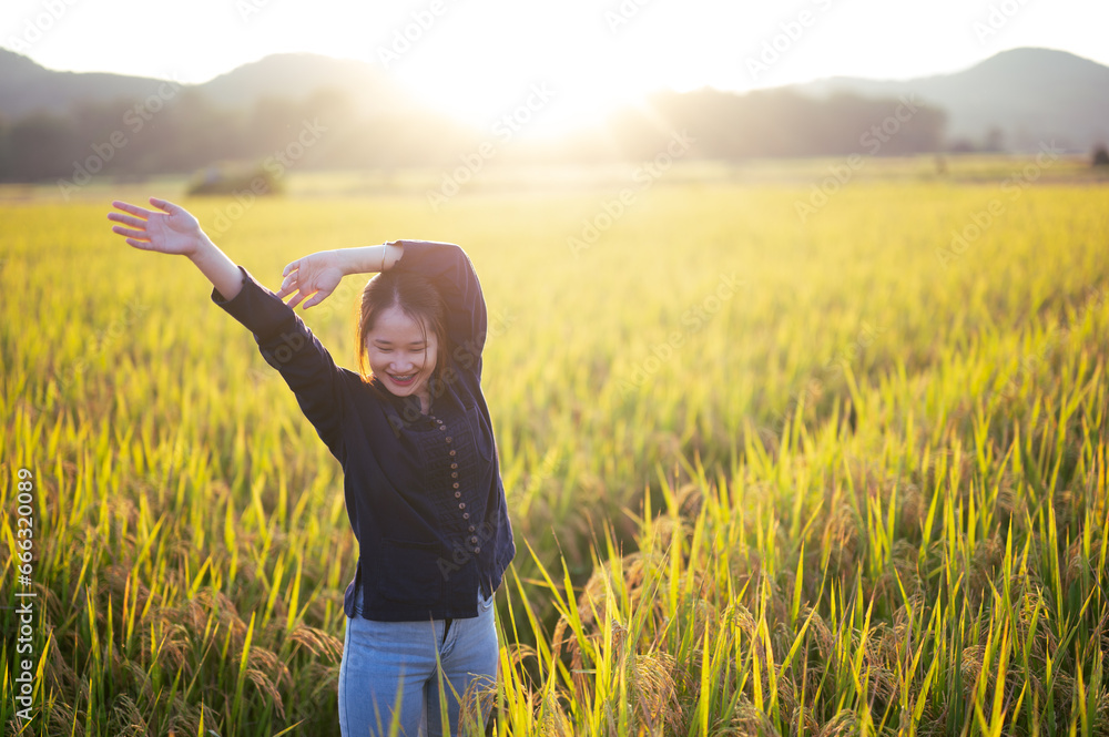 Free Happy Woman Enjoying Nature. Beauty Girl Outdoor. Freedom concept. Beauty Girl over Sky and Sunset on field rice. Sunbeams.Enjoyment. Free Happy Woman Enjoying Nature. Beauty Girl Outdoor. Freedom concept. Beauty Girl over Sky and Sunset on field rice. Sunbeams.Enjoyment.