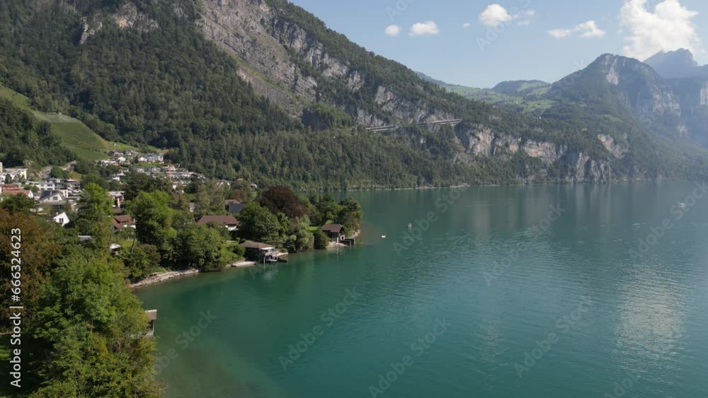 Drone flying over Weesen town based near shore of Walensee lake, Switzerland Drone flying over Weesen town based near shore of Walensee lake, Switzerland
