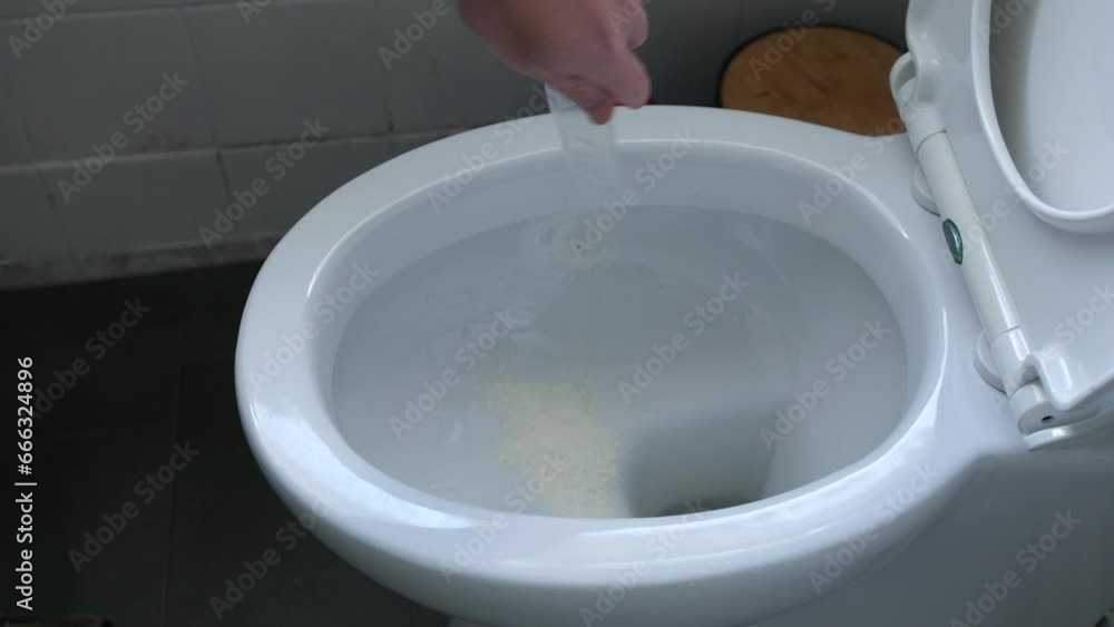 Drug addict tipping away and flushing drugs down the toilet. Disposing