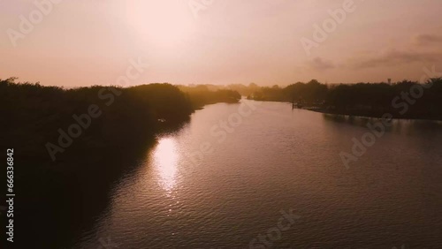 Aerial Sunset Dusk View at Beach Coastline, Laguna Glagah Lake, Indonesia photo