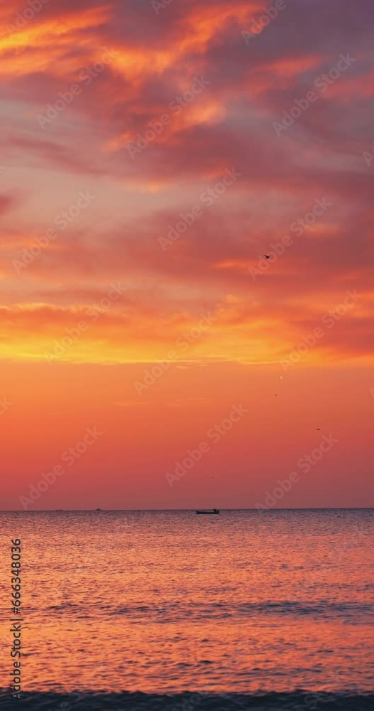 Tropical ocean color sunrise with scenic cludscape over ripple waves and beach shore. Sunrise of exotic island, vertical view 4K video Tropical ocean color sunrise with scenic cludscape over ripple waves and beach shore. Sunrise of exotic island, vertical view 4K video