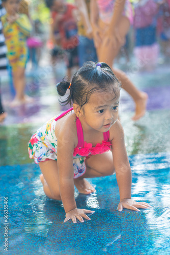 Beautiful asian toddler girl enjoying play outdoor city water park © themorningglory
